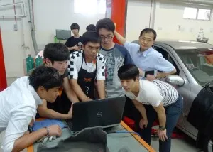 Ajou Motor College delegation head Prof Jie Myoung Seok (right) and his students paying close attention as a TOC trainer shows the results of a diagnostic equipment