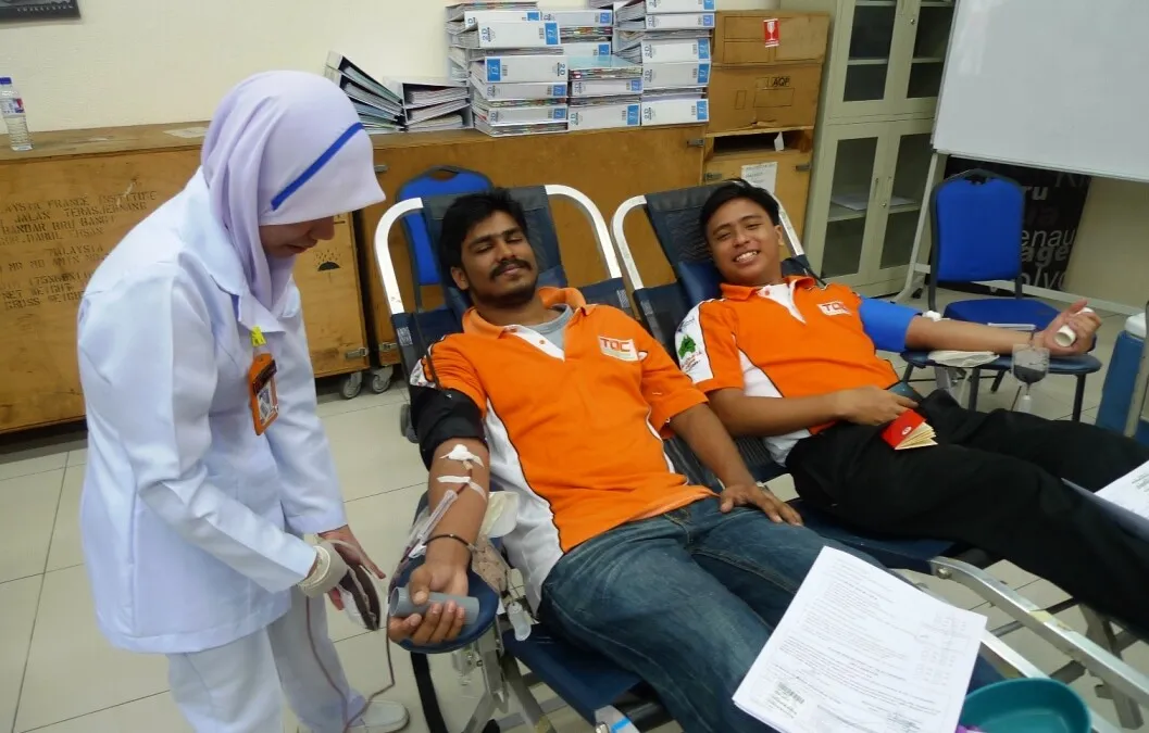 TOC students Darshan Ragunathan and Ikhwan Zulkifli doing their part at the recent blood donation drive.