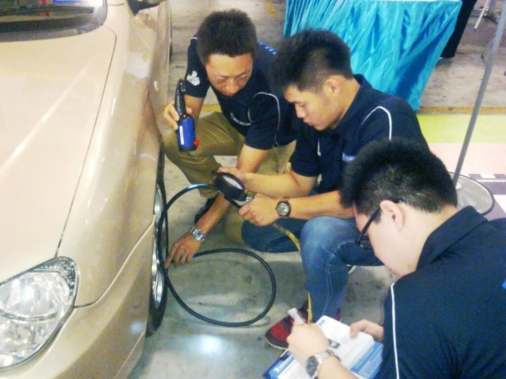 Michelin experts checking tyre pressure to ensure that the tyres are properly inflated
