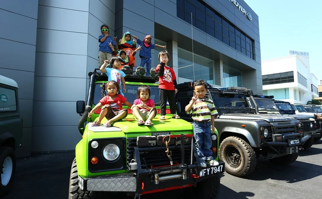 Adorable children in colourful clothes matched this colourful Land Rover Defender 110 Wagon perfectly
