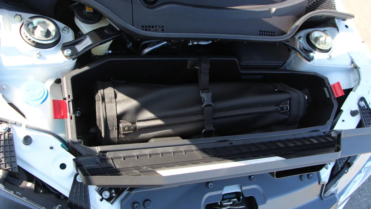 Rag-top detaches completely and rolls-up into the front 'boot' space...