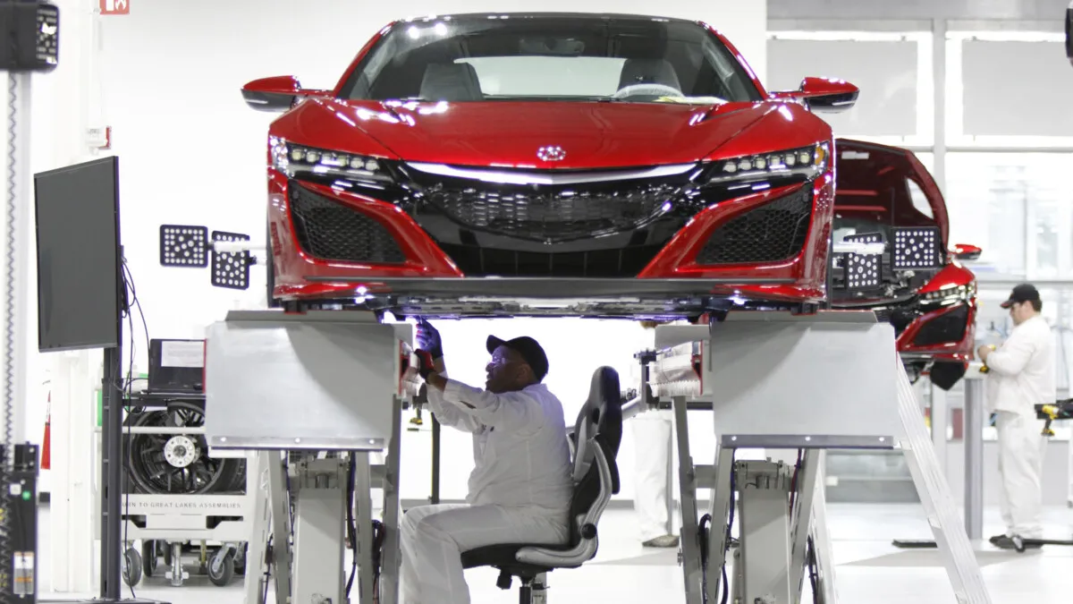 Carl Mason sits in the aligner chair during the wheel alignment process. Because the NSX is so low, associates would have had to be in a crouched position for long periods of time to perform its alignment. This special chair hangs on rails and allows an associate comfort while doing this 45-minute process.