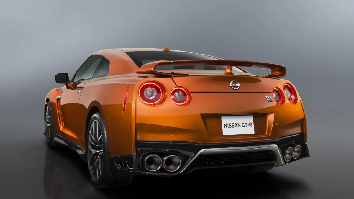 The 2017 GT-R's exterior receives a thorough makeover. The new "V-motion" grille, one of Nissan's latest design signatures, has been slightly enlarged to provide better engine cooling and now features a matte chrome finish and an updated mesh pattern. A new hood, featuring pronounced character lines flowing flawlessly from the grille, has been reinforced to enhance stability during high-speed driving. A freshly designed front spoiler lip and front bumpers with finishers situated immediately below the headlamps give the new GT-R the look of a pure-bred racecar, while generating high levels of front downforce.