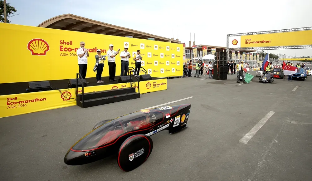 The Nanyang Venture IX, #305, a battery electric prototype vehicle from team Nanyang E Drive at the Nanyang Technological University in Singapore, Singapore, passes by Simon Henry, Chief Financial Officer of Royal Dutch Shell, left, and Honorable Zenaida Mondsada at the opening ceremony during day two of the Shell Eco-marathon Asia, in Manila, Philippines, Friday, March 4, 2016. during day two of the Shell Eco-marathon Asia in Manila, Philippines, Friday, March 4, 2016. (Geloy Concepcion via AP Images)