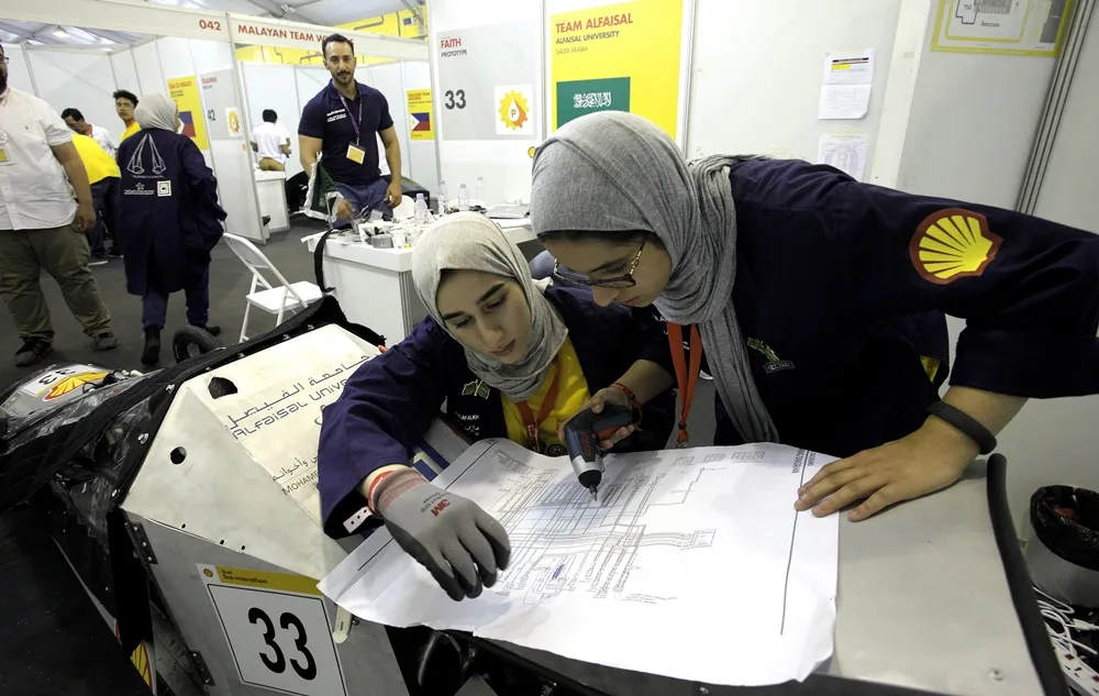Team members work on the Faith, #33, a gasoline prototype vehicle from Team Alfaisal at the Alfaisal University in Riyadh, Saudi Arabia,  during day two of the Shell Eco-marathon Asia in Manila, Philippines, Friday, March 4, 2016. (Geloy Concepcion via AP Images)