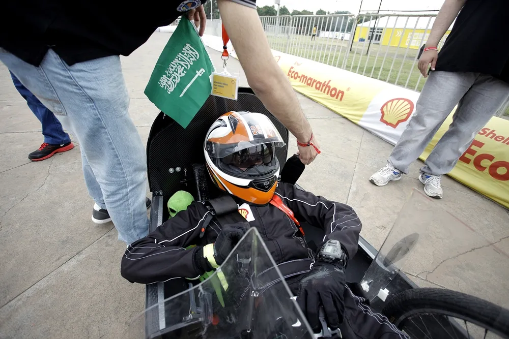 Team members of the Riyadh/2, #12, a gasoline prototype vehicle from team Saaf at the King Saud University in Riyadh, Saudi Arabia, ready their car for a run during day two of the Shell Eco-marathon Asia in Manila, Philippines, Friday, March 4, 2016. (Geloy Concepcion via AP Images)