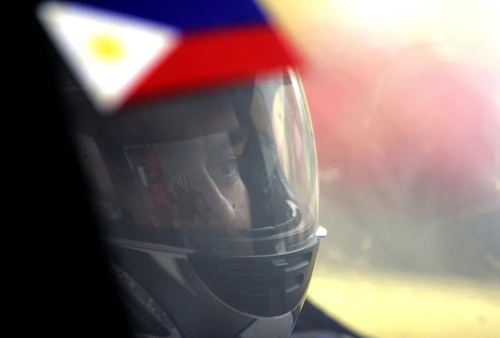 The driver of the Liwanag, #704, a battery electric UrbanConcept vehicle from Team UP at the University of the Philippines - Diliman in Quezon City, Philippines, is seen through its windshield as it runs a lap during day two of the Shell Eco-marathon Asia in Manila, Philippines, Friday, March 4, 2016. (Geloy Concepcion via AP Images)