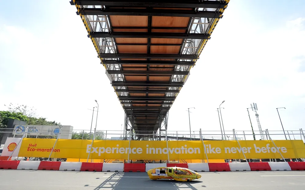 The aristo evo-3, #306, a battery electric prototype vehicle from Apatte 62 Team at the Universitas Brawijaya in Malang, Indonesia, passes under a walkway during day three of the Shell Eco-marathon Asia in Manila, Philippines, Saturday, March 5, 2016. (Jinggo Montenejo  via AP Images)