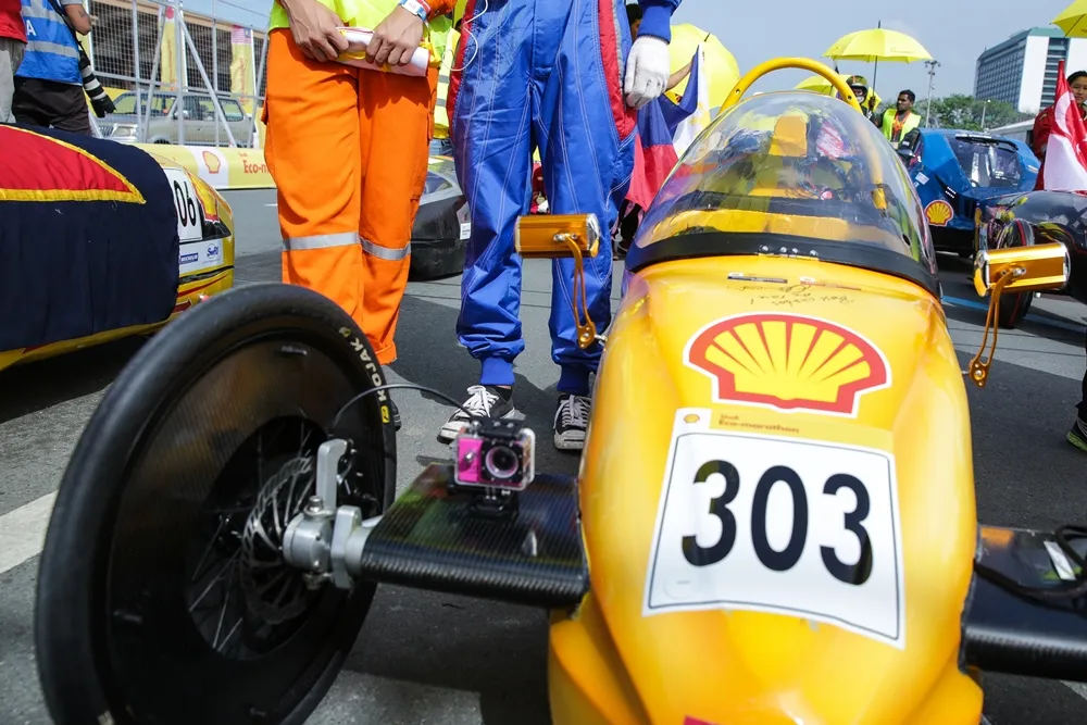 The EcoTraveller, #303, a battery electric prototype vehicle from team EcoTraveller at the Institute of Technical Education (ITE) in Singapore, is moved into position at the opening ceremony during day two of the Shell Eco-marathon Asia, in Manila, Philippines, Friday, March 4, 2016. (Kay Edwards/AP Images for Shell)