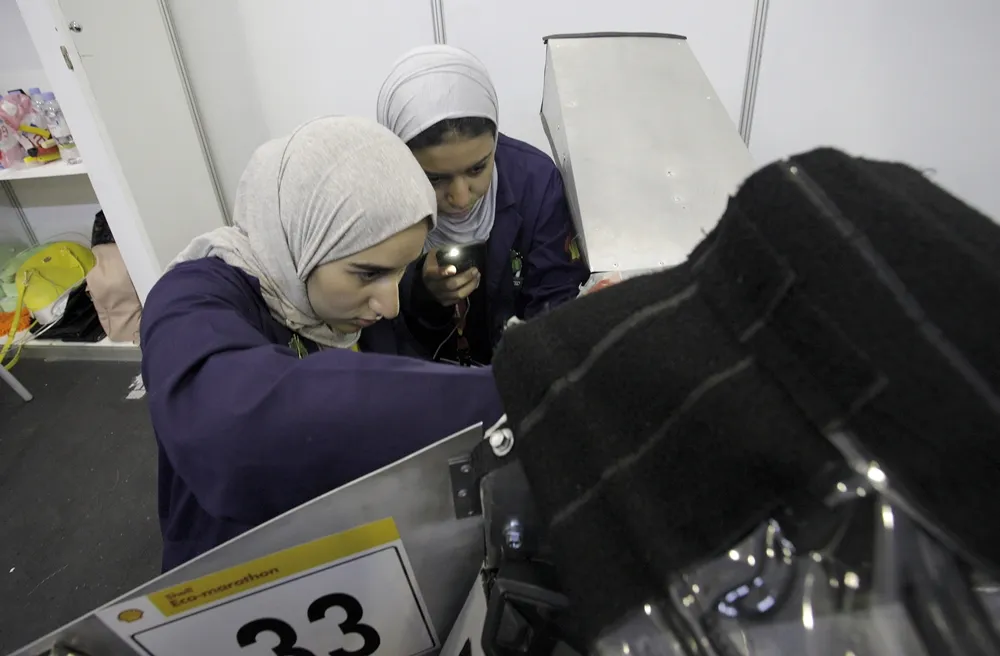 Team members work on the Faith, #33, a gasoline prototype vehicle from Team Alfaisal at the Alfaisal University in Riyadh, Saudi Arabia,  during day two of the Shell Eco-marathon Asia in Manila, Philippines, Friday, March 4, 2016. (Geloy Concepcion via AP Images)