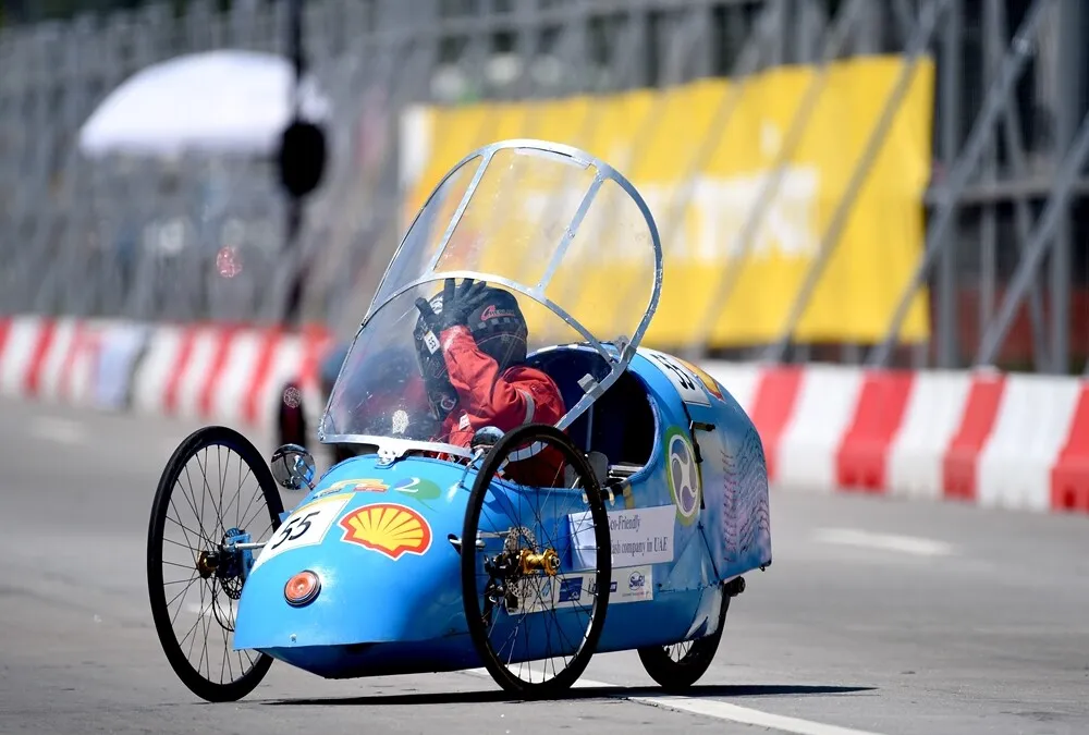 The driver of the Eco Stallion 3.0, #55, a diesel prototype vehicle from team Vision 2020 at the American University of Sharjah in Sharjah, United Arab Emirates, opens the canopy of his car on the track during day three of the Shell Eco-marathon Asia in Manila, Philippines, Saturday, March 5, 2016. (Jinggo Montenejo  via AP Images)