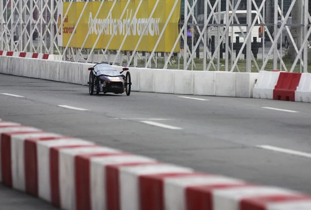 The EVE II, #53, a diesel prototype vehicle from team PUP-Hygears at the Polytechnic University of the Philippines - Manila in Manila, Philippines, leads other cars through a straightaway on the track during the final day of the Shell Eco-marathon Asia, in Manila, Philippines, Sunday, March 6, 2016. (Geloy Concepcion/AP Images for Shell)