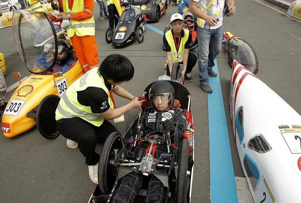 A team member readies the CD04-evo., #2, a diesel prototype vehicle from Clean diesel Team at the Hyogo Prefectural Tajima Technical Institute in Toyooka, Japan, at the starting line during day two of the Shell Eco-marathon Asia in Manila, Philippines, Friday, March 4, 2016. (Geloy Concepcion via AP Images)