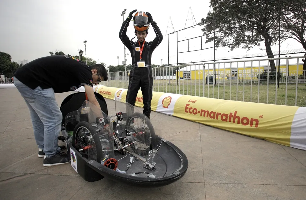 Team members of the Riyadh/2, #12, a gasoline prototype vehicle from team Saaf at the King Saud University in Riyadh, Saudi Arabia, ready their car for a run during day two of the Shell Eco-marathon Asia in Manila, Philippines, Friday, March 4, 2016. (Geloy Concepcion via AP Images)