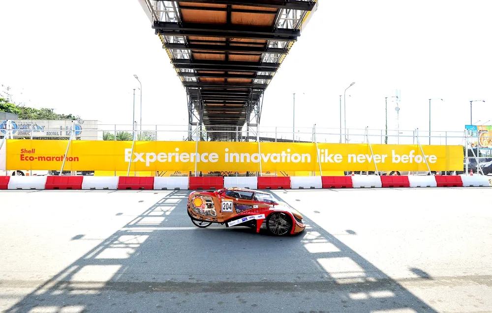 The Nakhoda, #204, a hydrogen prototype vehicle from team GenNext Pejuang at the Universiti Brunei Darussalam in Bandar Seri Begawan, Brunei Darussalam, passes under a walkway during day three of the Shell Eco-marathon Asia in Manila, Philippines, Saturday, March 5, 2016. (Jinggo Montenejo  via AP Images)