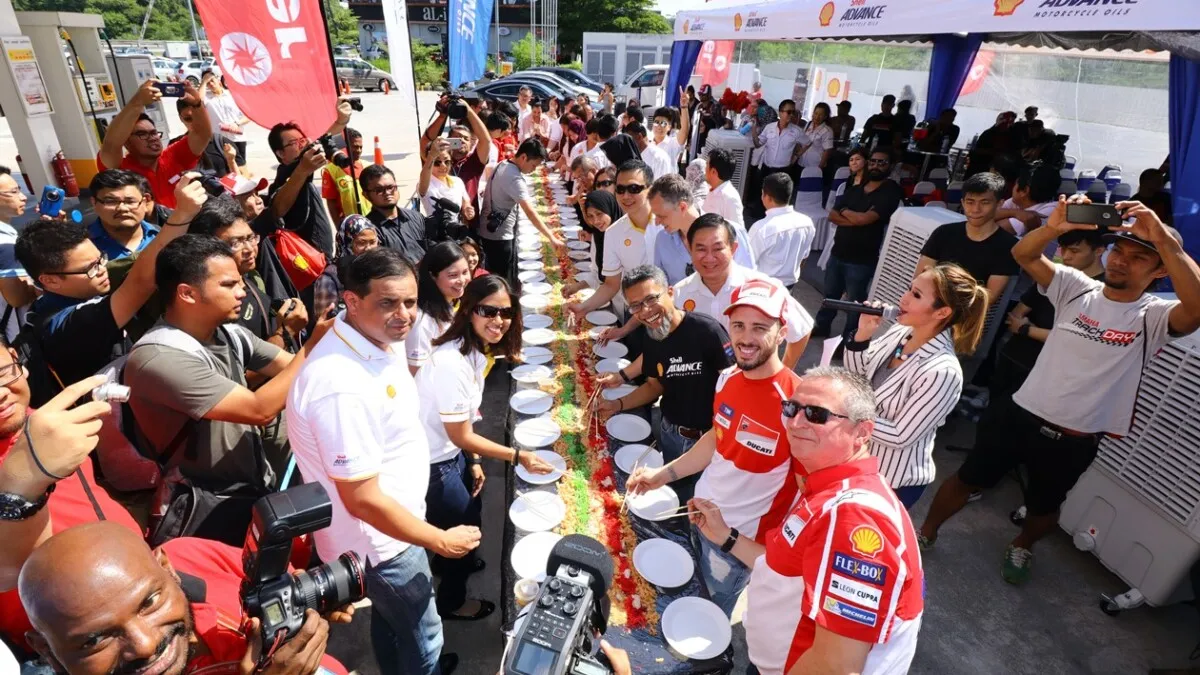 Ducati's Andrea Dovizioso trying yee sang tossing accompanied by Shell M... (1)