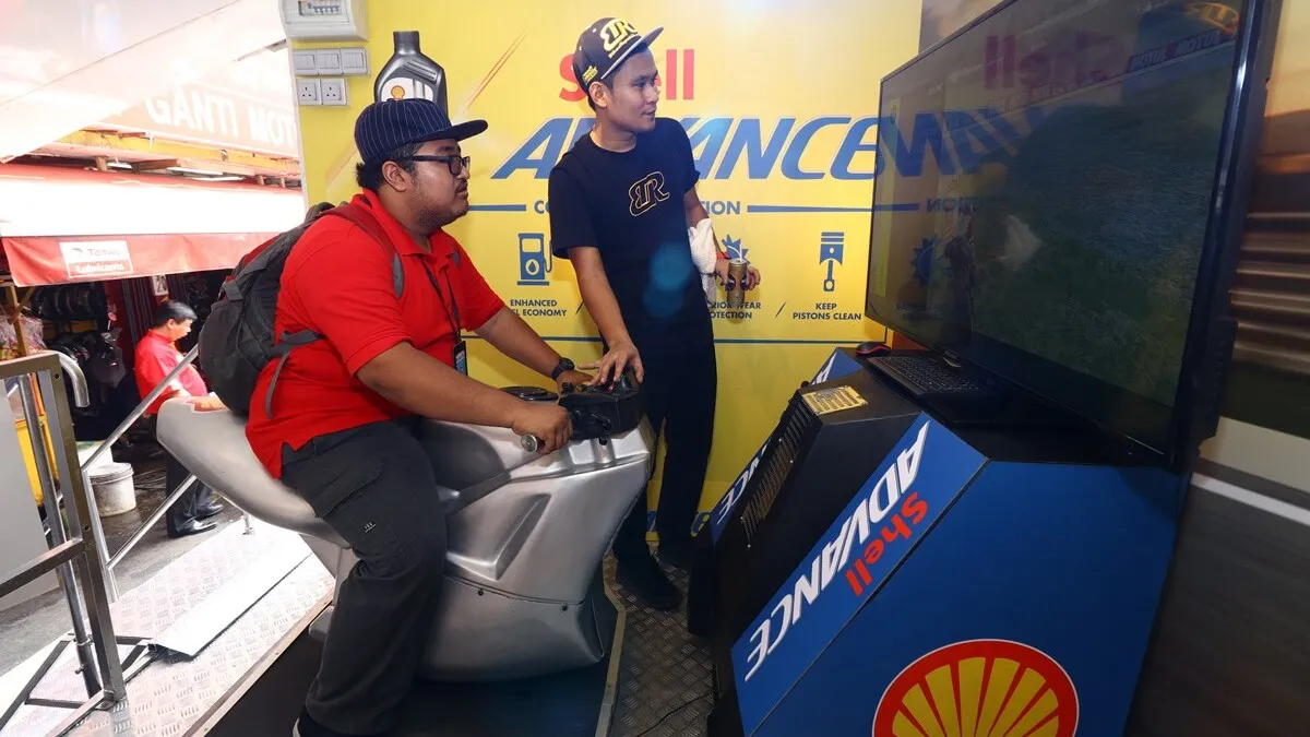 Trying out the bike simulator at the Shell Advance roadshow